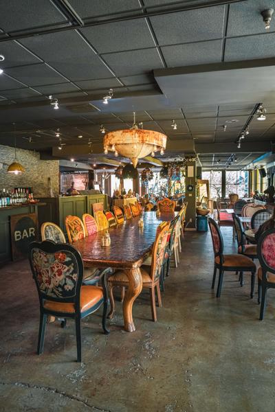 A Turkish-style restaurant seen from inside with concrete floors and colorful lamps.