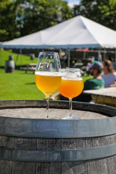 Two glasses of beer on a barrel at Hill Farmstead Brewery.