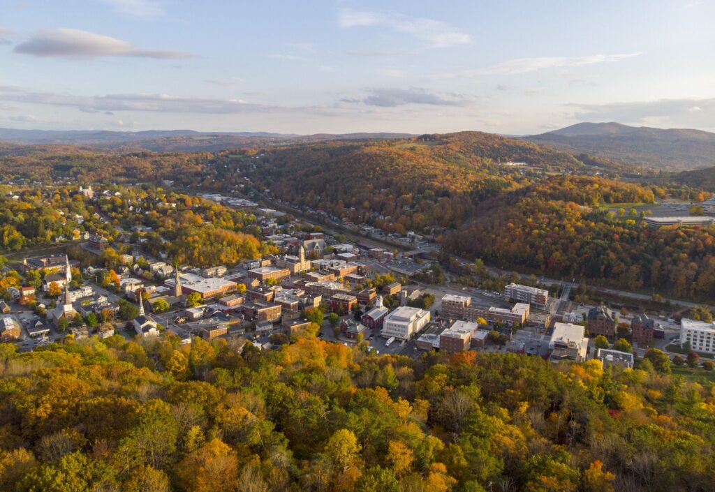 Seen from above, a historic downtown in the fall among mountains. 