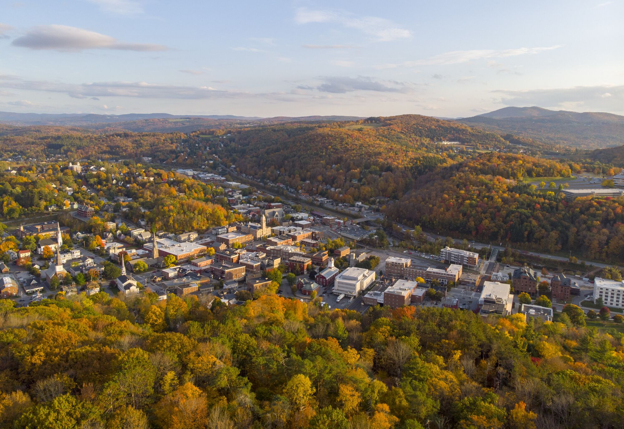 Seen from above, a historic downtown in the fall among mountains.