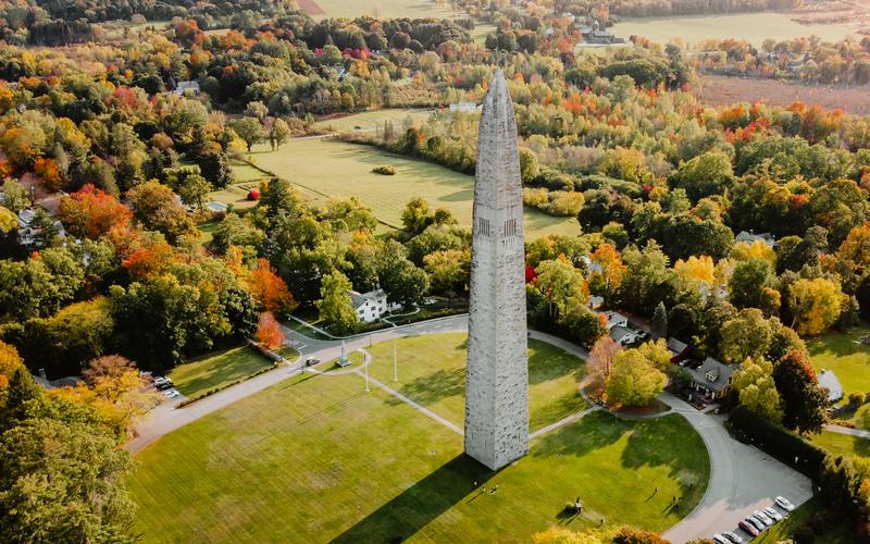 Aerial view of the Bennington Monument surrounded by colorful fall foliage.