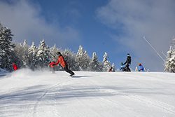 Snowboarders coming down the mountain in Vermont.