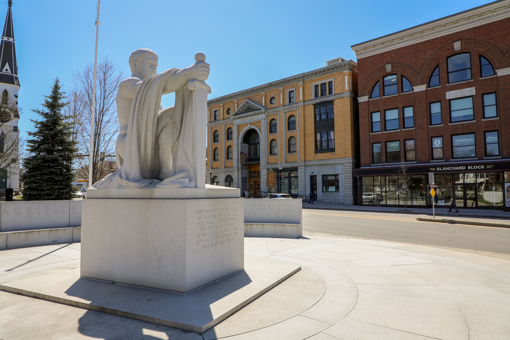 A granite statue in a city center in Vermont.