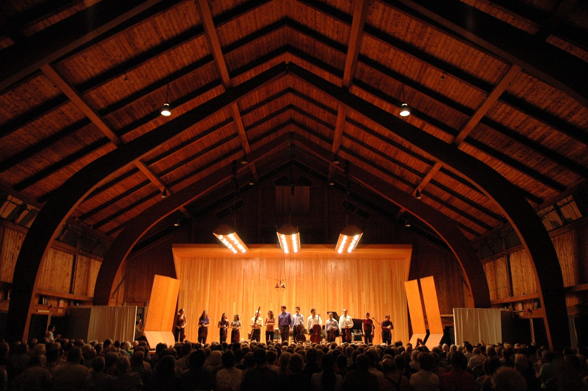 A group of musicians stands on a stage in Vermont.