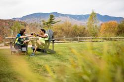 Two people sit in chairs outside in Vermont.