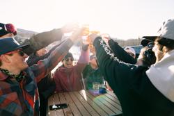A group of people raise their cups outdoors in Vermont.