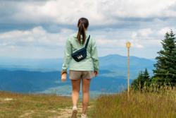 A hiker walks toward a mountain in Vermont.