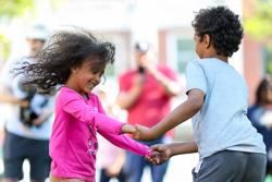 Two children dancing outside in Vermont.