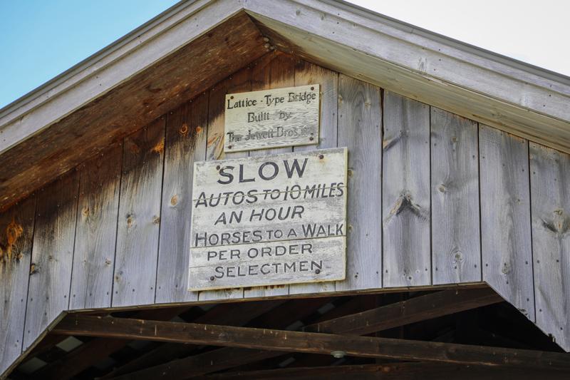 Signs on a covered bridge in Vermont.