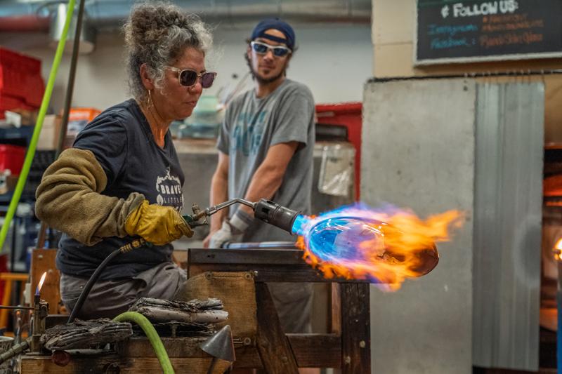 A person works on a glass art project in Vermont.