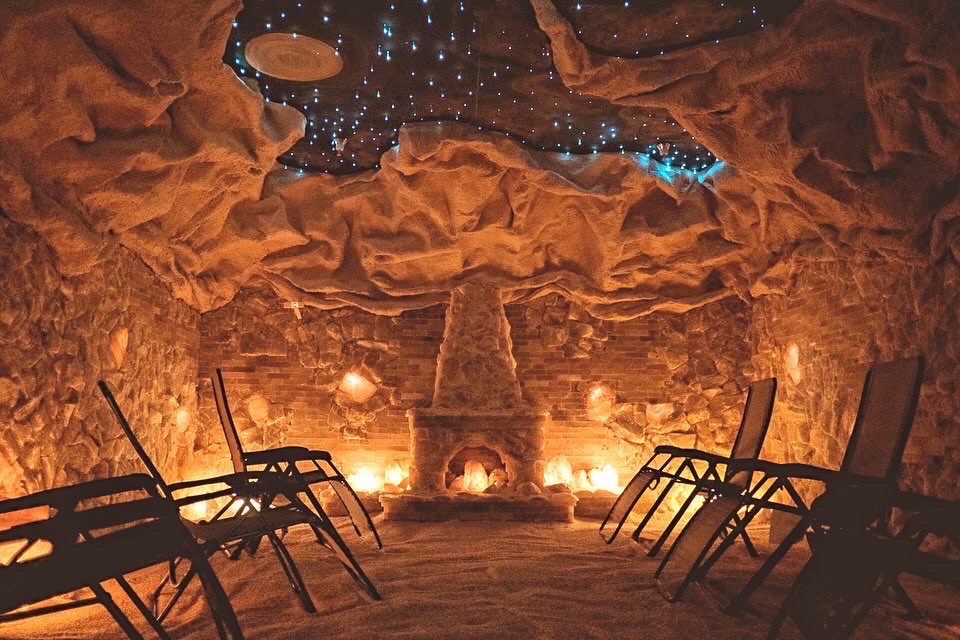 A salt cave area with chairs and a glowing fireplace in Vermont.