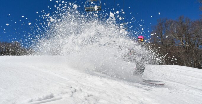 A skier sprays snow on a mountain in Vermont.