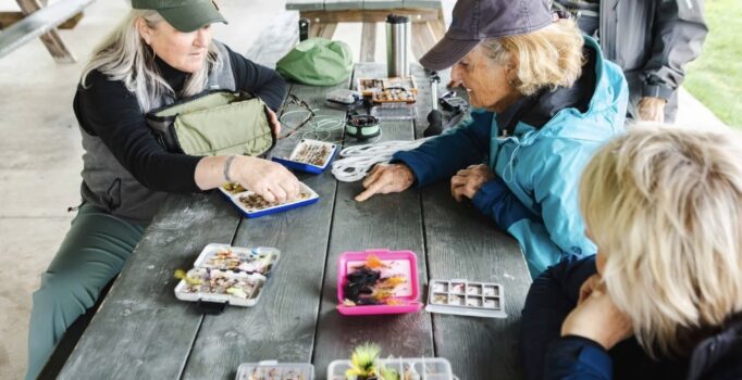 Two people tie fishing flies.