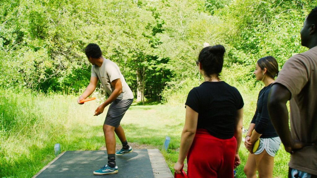 A group playing disc golf.