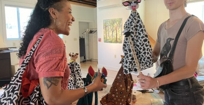 A puppeteer demonstrates a puppet.