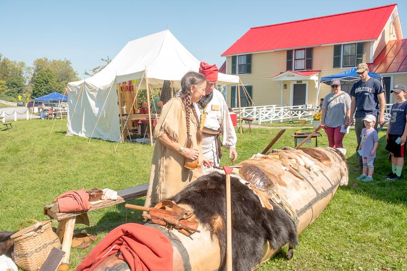 Two historians demonstrate native American practices for a young family in Vermont.