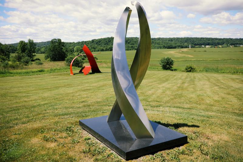 Abstract outdoor metal sculptures displayed on a grassy lawn at the Lemon Fair Sculpture Park in Shoreham, Vermont.